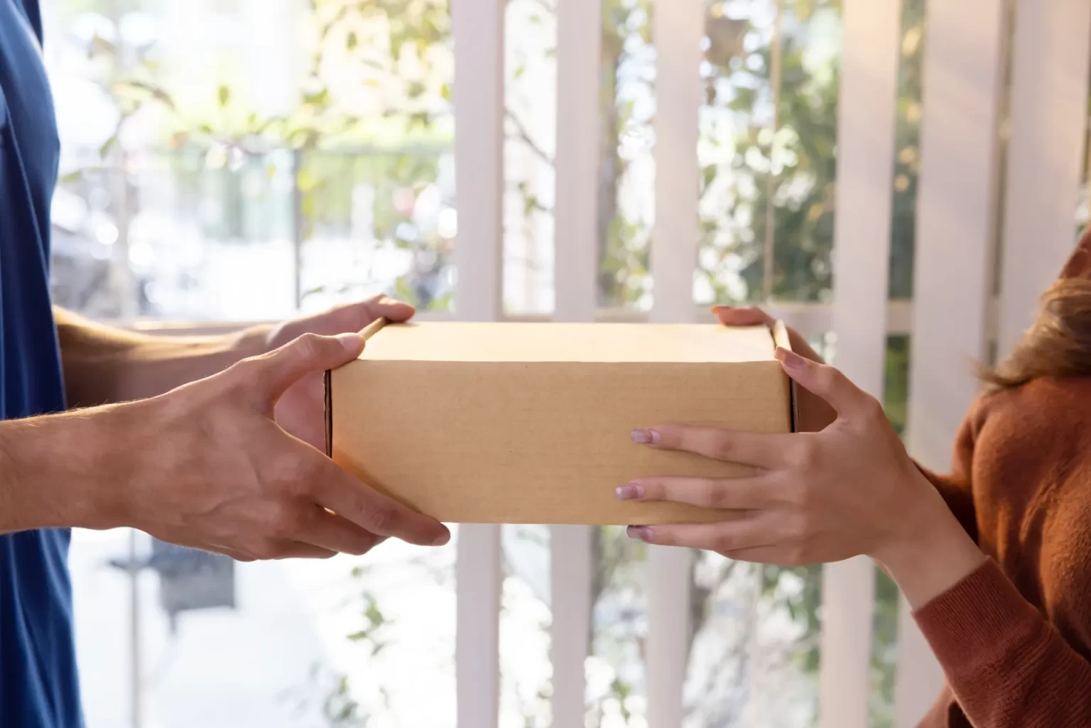 close up on delivery man s hand delivering a card utc ()